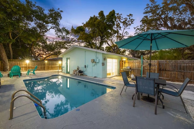 201 S St, Palm Harbor, FL 34683 - view of swimming pool featuring a patio, a fenced backyard, and outdoor dining area
