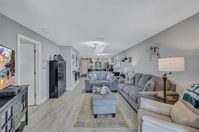 900 Maclaren Dr N Unit D, Palm Harbor, FL 34684 - living area with light wood-style flooring and baseboards