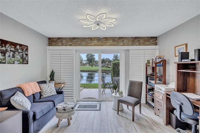 900 Maclaren Dr N Unit D, Palm Harbor, FL 34684 - living area with light wood-style floors, a textured ceiling, a water view, and an office area