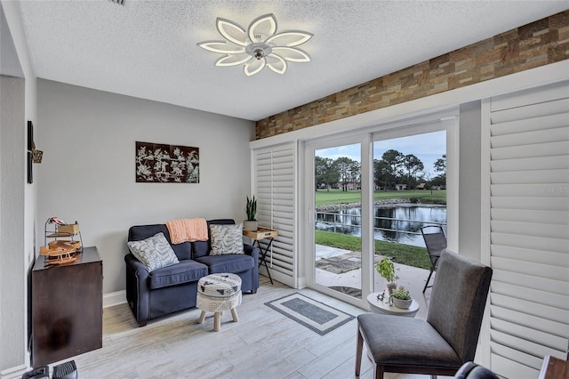 900 Maclaren Dr N Unit D, Palm Harbor, FL 34684 - living area with a water view, a textured ceiling, and wood finished floors
