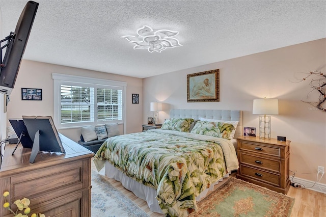 900 Maclaren Dr N Unit D, Palm Harbor, FL 34684 - bedroom featuring light wood finished floors and a textured ceiling