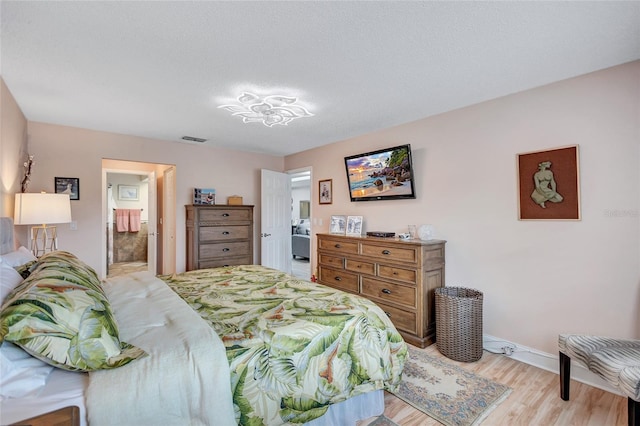 900 Maclaren Dr N Unit D, Palm Harbor, FL 34684 - bedroom featuring light wood-type flooring and a textured ceiling