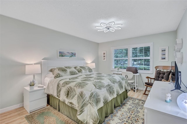 900 Maclaren Dr N Unit D, Palm Harbor, FL 34684 - bedroom featuring light wood-style flooring and a textured ceiling