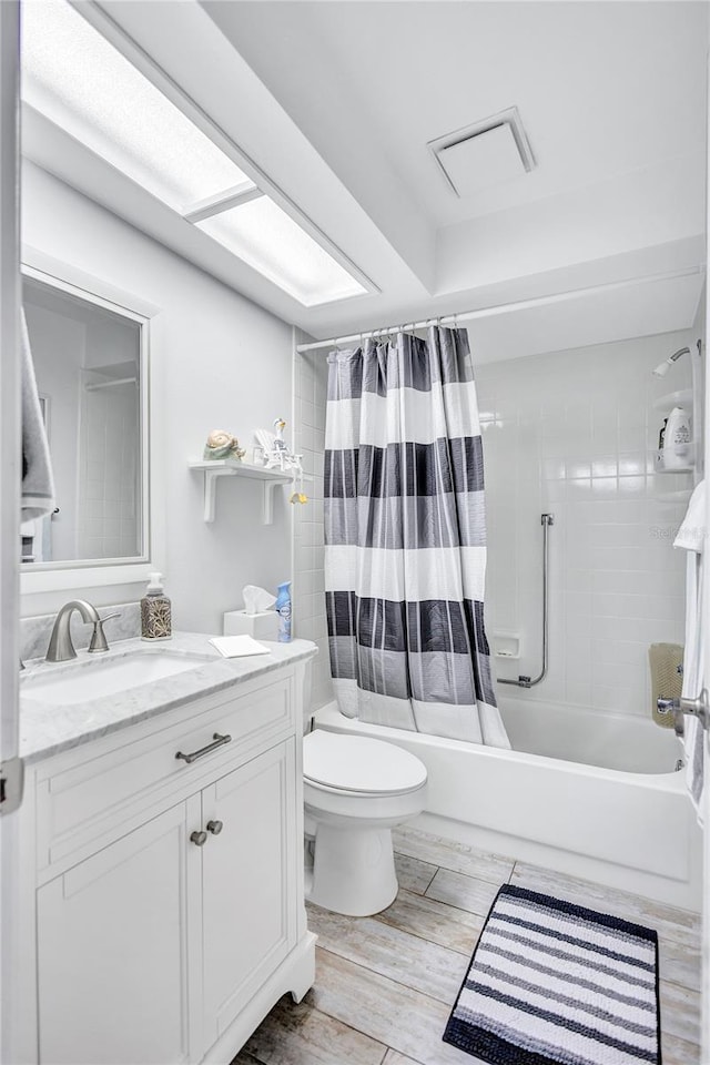 900 Maclaren Dr N Unit D, Palm Harbor, FL 34684 - bathroom featuring vanity, shower / bath combo, and wood finished floors