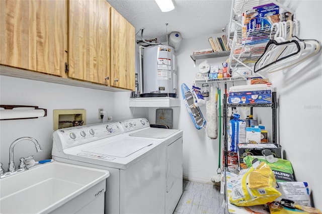 900 Maclaren Dr N Unit D, Palm Harbor, FL 34684 - washroom with cabinet space, gas water heater, separate washer and dryer, a textured ceiling, and light wood-type flooring
