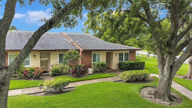 900 Maclaren Dr N Unit D, Palm Harbor, FL 34684 - view of front of property featuring a front yard and a shingled roof