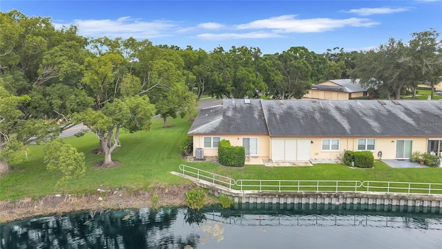 900 Maclaren Dr N Unit D, Palm Harbor, FL 34684 - rear view of house with a lawn, a water view, and stucco siding