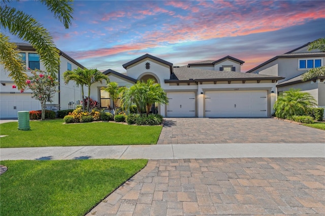 12607 Pensacola Ct, Riverview, FL 33579 - view of front of home with decorative driveway, an attached garage, a lawn, and stucco siding