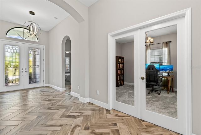 12607 Pensacola Ct, Riverview, FL 33579 - entrance foyer featuring a chandelier, french doors, arched walkways, and plenty of natural light