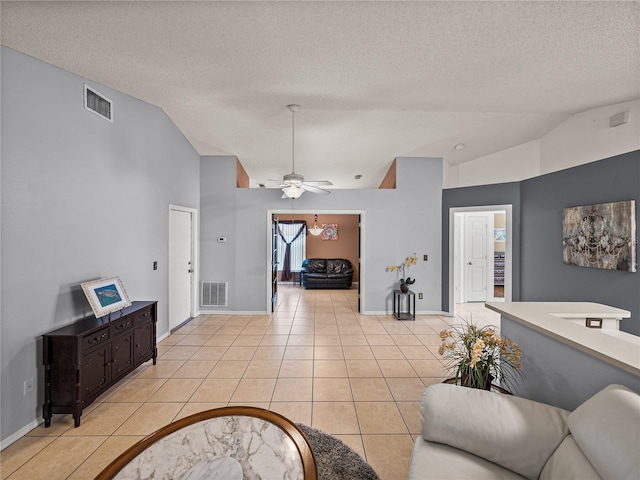 22829 Saint Thomas Cir, Lutz, FL 33549 - living area with vaulted ceiling, light tile patterned floors, a textured ceiling, and a ceiling fan