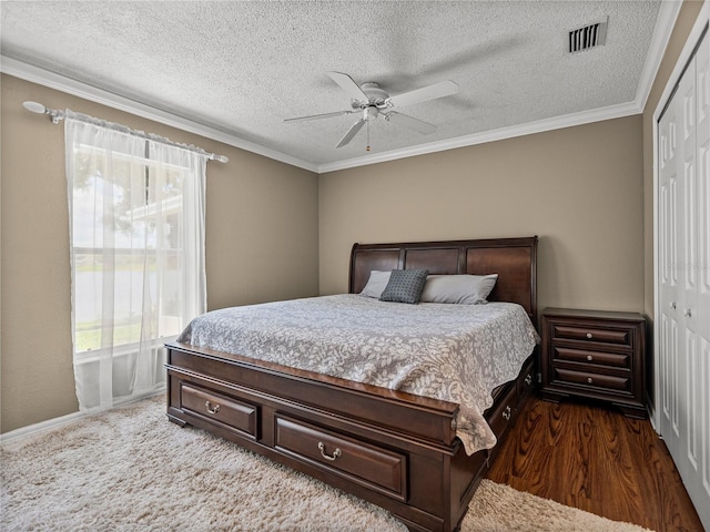 22829 Saint Thomas Cir, Lutz, FL 33549 - bedroom with a closet, crown molding, a ceiling fan, and a textured ceiling
