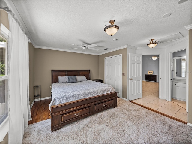 22829 Saint Thomas Cir, Lutz, FL 33549 - bedroom featuring a textured ceiling, a closet, crown molding, and light tile patterned floors