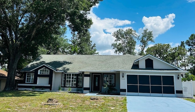 10444 Fordham St, Spring Hill, FL 34608 - ranch-style house with driveway, an attached garage, roof with shingles, and stucco siding