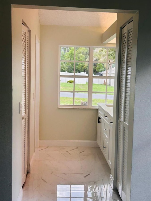 10444 Fordham St, Spring Hill, FL 34608 - bathroom featuring a closet, marble look tiles, and vanity