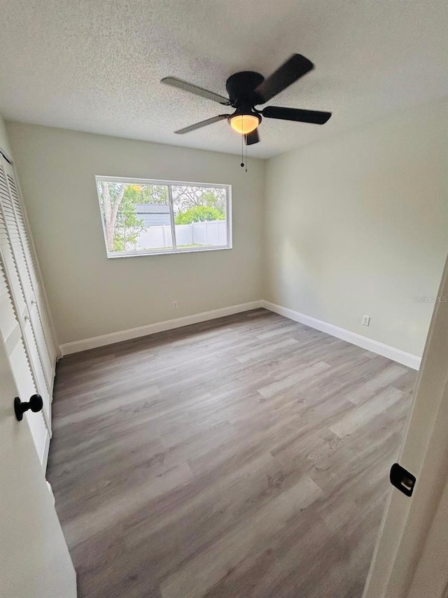 10444 Fordham St, Spring Hill, FL 34608 - empty room with a ceiling fan, wood finished floors, and a textured ceiling