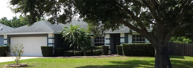 2509 Montecito Ave, Eustis, FL 32726 - view of front of property featuring an attached garage, a shingled roof, and concrete driveway