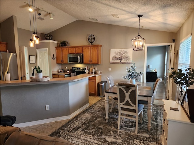 2509 Montecito Ave, Eustis, FL 32726 - dining area with lofted ceiling, track lighting, a textured ceiling, and a chandelier
