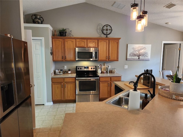 2509 Montecito Ave, Eustis, FL 32726 - kitchen with appliances with stainless steel finishes, vaulted ceiling, light countertops, light floors, and brown cabinetry