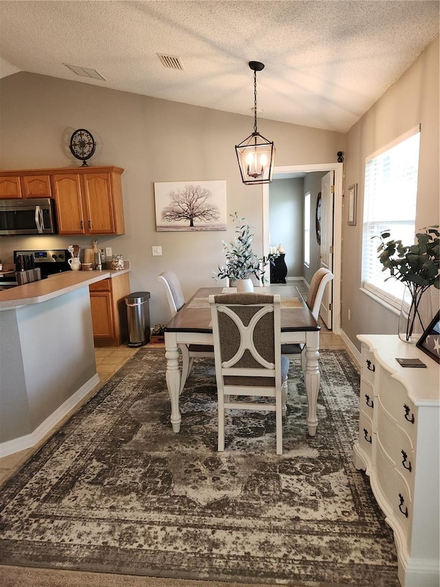 2509 Montecito Ave, Eustis, FL 32726 - dining area featuring lofted ceiling, a chandelier, and a textured ceiling