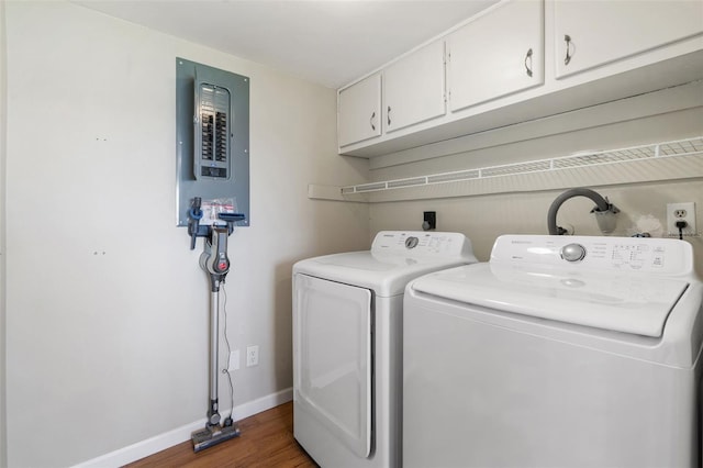 9209 Seminole Blvd Unit 13, Seminole, FL 33772 - washroom featuring electric panel, cabinet space, wood finished floors, and washer and dryer