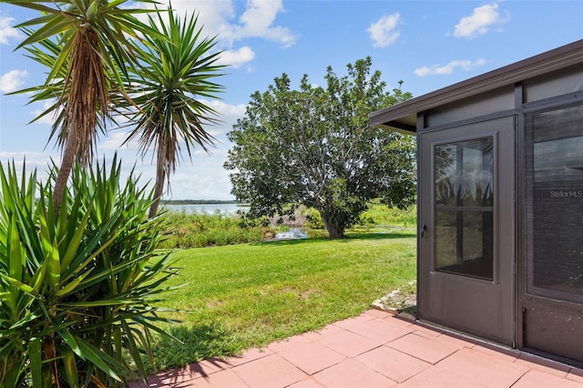 9209 Seminole Blvd Unit 13, Seminole, FL 33772 - view of green lawn with a water view and a patio area