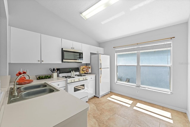 547 Summer Sails Dr, Valrico, FL 33594 - kitchen featuring white appliances, vaulted ceiling, white cabinets, light countertops, and light tile patterned flooring