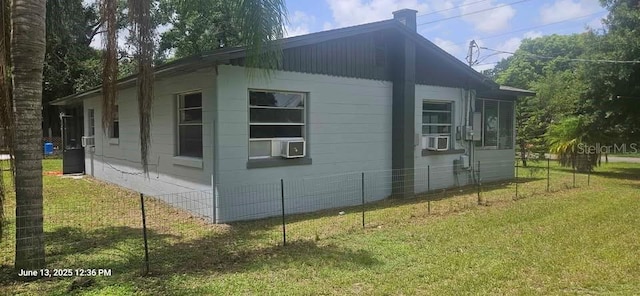 1908 S Kingsway Rd, Seffner, FL 33584 - view of side of home featuring a yard, cooling unit, and a chimney