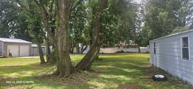 1908 S Kingsway Rd, Seffner, FL 33584 - view of green lawn featuring a garage and a storage shed