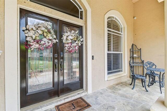 17906 Loretta Ln, Lutz, FL 33548 - doorway to property with french doors and stucco siding
