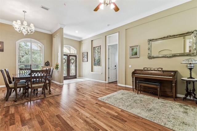 17906 Loretta Ln, Lutz, FL 33548 - entryway featuring ornamental molding, wood finished floors, a chandelier, and a ceiling fan