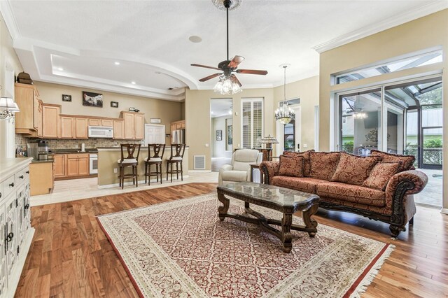 17906 Loretta Ln, Lutz, FL 33548 - living room with a ceiling fan, crown molding, light wood-style floors, a chandelier, and recessed lighting
