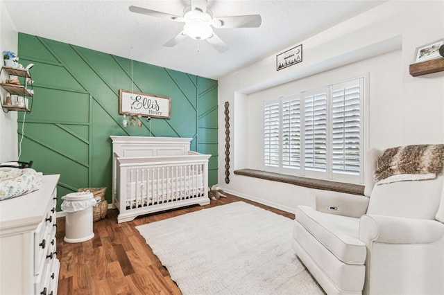 17906 Loretta Ln, Lutz, FL 33548 - bedroom with wood finished floors, a crib, and a ceiling fan