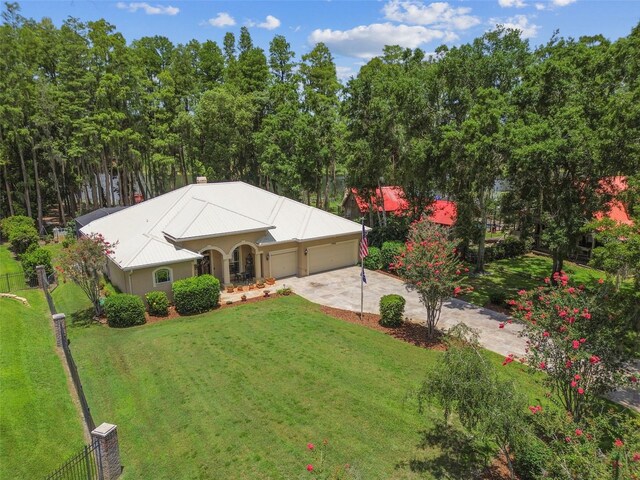 17906 Loretta Ln, Lutz, FL 33548 - view of front of home with concrete driveway, a garage, and a metal roof