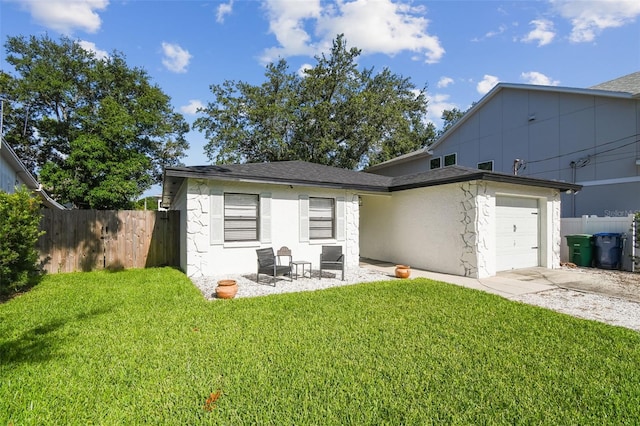 206 N Beverly Ave Unit 1/2, Tampa, FL 33609 - rear view of property with a garage, concrete driveway, stucco siding, and roof with shingles