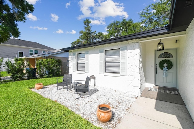 206 N Beverly Ave Unit 1/2, Tampa, FL 33609 - doorway to property featuring a yard, stucco siding, and a patio