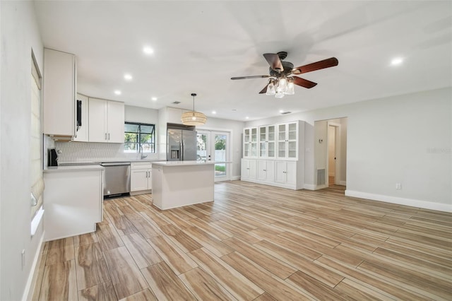 206 N Beverly Ave Unit 1/2, Tampa, FL 33609 - kitchen featuring stainless steel appliances, light countertops, a kitchen island, open floor plan, and recessed lighting