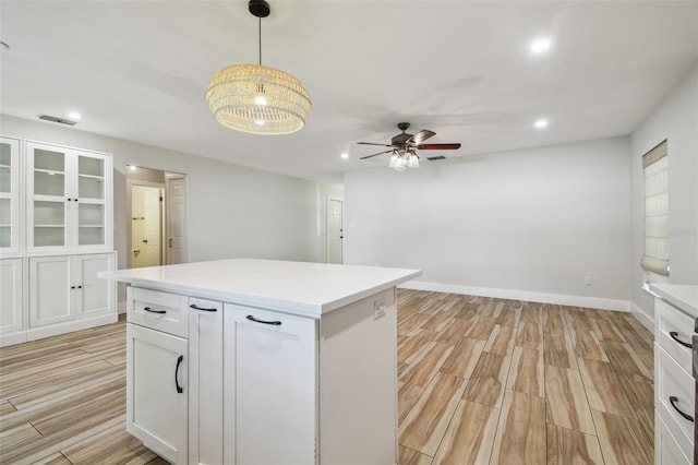 206 N Beverly Ave Unit 1/2, Tampa, FL 33609 - kitchen with light wood-style flooring, white cabinetry, ceiling fan, light countertops, and recessed lighting