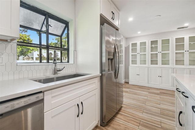 206 N Beverly Ave Unit 1/2, Tampa, FL 33609 - kitchen with appliances with stainless steel finishes, light countertops, white cabinetry, and recessed lighting