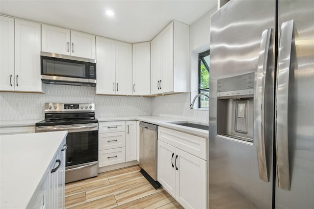 206 N Beverly Ave Unit 1/2, Tampa, FL 33609 - kitchen with stainless steel appliances, decorative backsplash, and light countertops