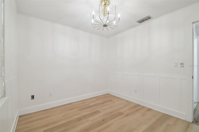 206 N Beverly Ave Unit 1/2, Tampa, FL 33609 - unfurnished dining area with a chandelier, light wood-style floors, and wainscoting