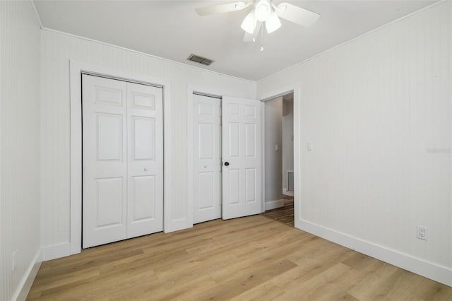 206 N Beverly Ave Unit 1/2, Tampa, FL 33609 - unfurnished bedroom with two closets, crown molding, light wood-style flooring, and a ceiling fan