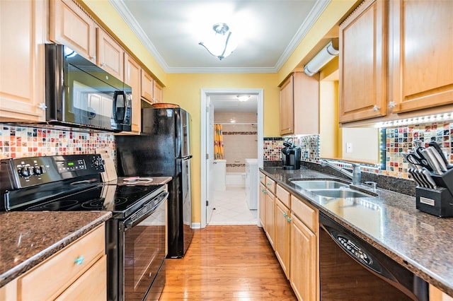 2025 Jefferson Ave, Dunedin, FL 34698 - kitchen featuring black appliances, washer and dryer, light brown cabinets, crown molding, and tasteful backsplash