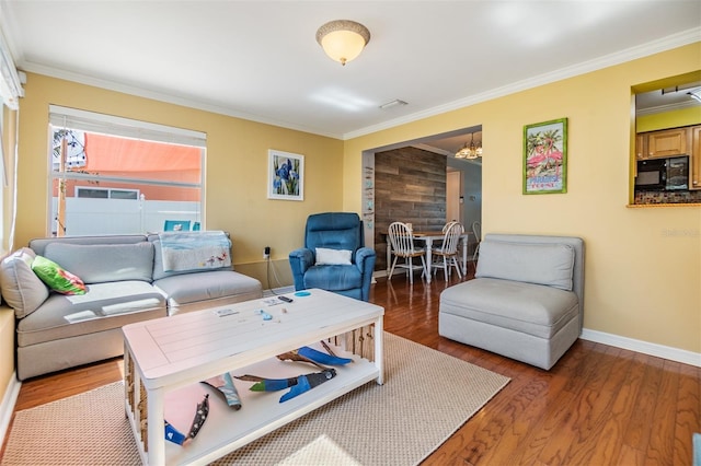 2025 Jefferson Ave, Dunedin, FL 34698 - living area featuring ornamental molding, wood finished floors, and a chandelier
