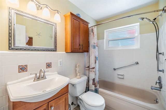 2025 Jefferson Ave, Dunedin, FL 34698 - full bath with vanity, tile walls, shower / tub combo, and a wainscoted wall