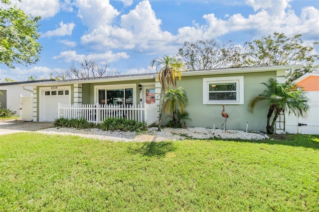 2025 Jefferson Ave, Dunedin, FL 34698 - ranch-style home featuring a garage, stucco siding, and driveway