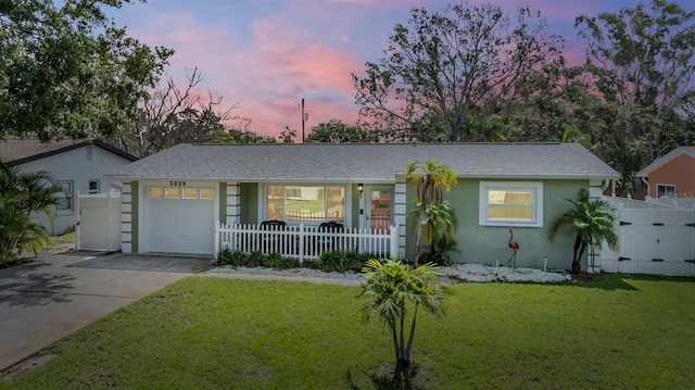 2025 Jefferson Ave, Dunedin, FL 34698 - ranch-style home featuring an attached garage, driveway, covered porch, and stucco siding