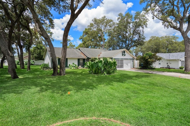 5301 Bayonne Ave, Spring Hill, FL 34608 - ranch-style home with driveway, an attached garage, and a front lawn