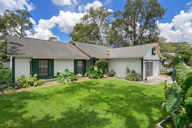 5301 Bayonne Ave, Spring Hill, FL 34608 - view of front facade featuring a front lawn and roof with shingles