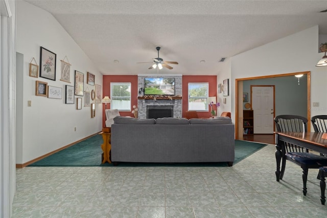 5301 Bayonne Ave, Spring Hill, FL 34608 - living room featuring a ceiling fan, a fireplace, and a textured ceiling