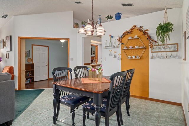 5301 Bayonne Ave, Spring Hill, FL 34608 - dining room with a chandelier, lofted ceiling, and a textured ceiling